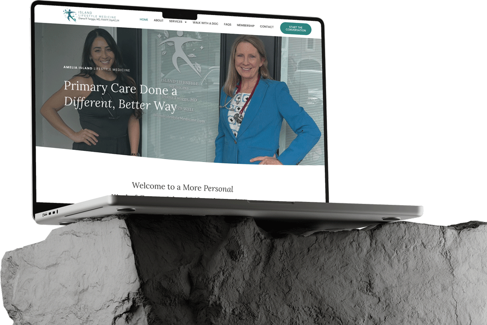 A laptop rests on a rock, displaying an Edit Website for Island Direct Primary Care. The site features two women standing and smiling, with text reading, "Primary Care Done a Different, Better Way.