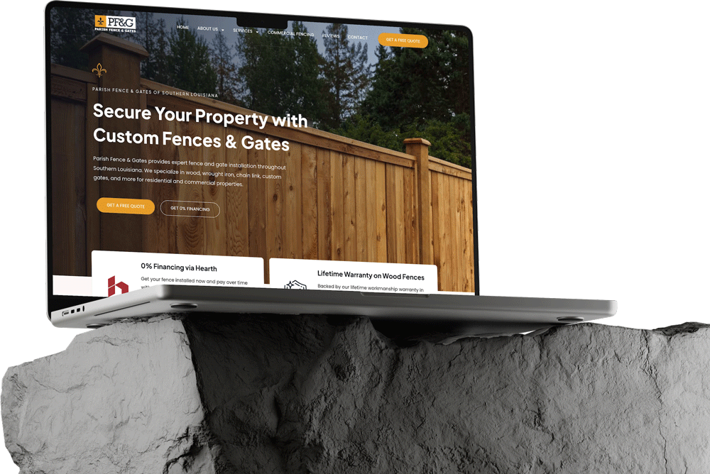 A laptop sits on a gray, textured rock, displaying a website build for a fencing company with a large wooden fence image, company logo, and text promoting custom fences and gates.