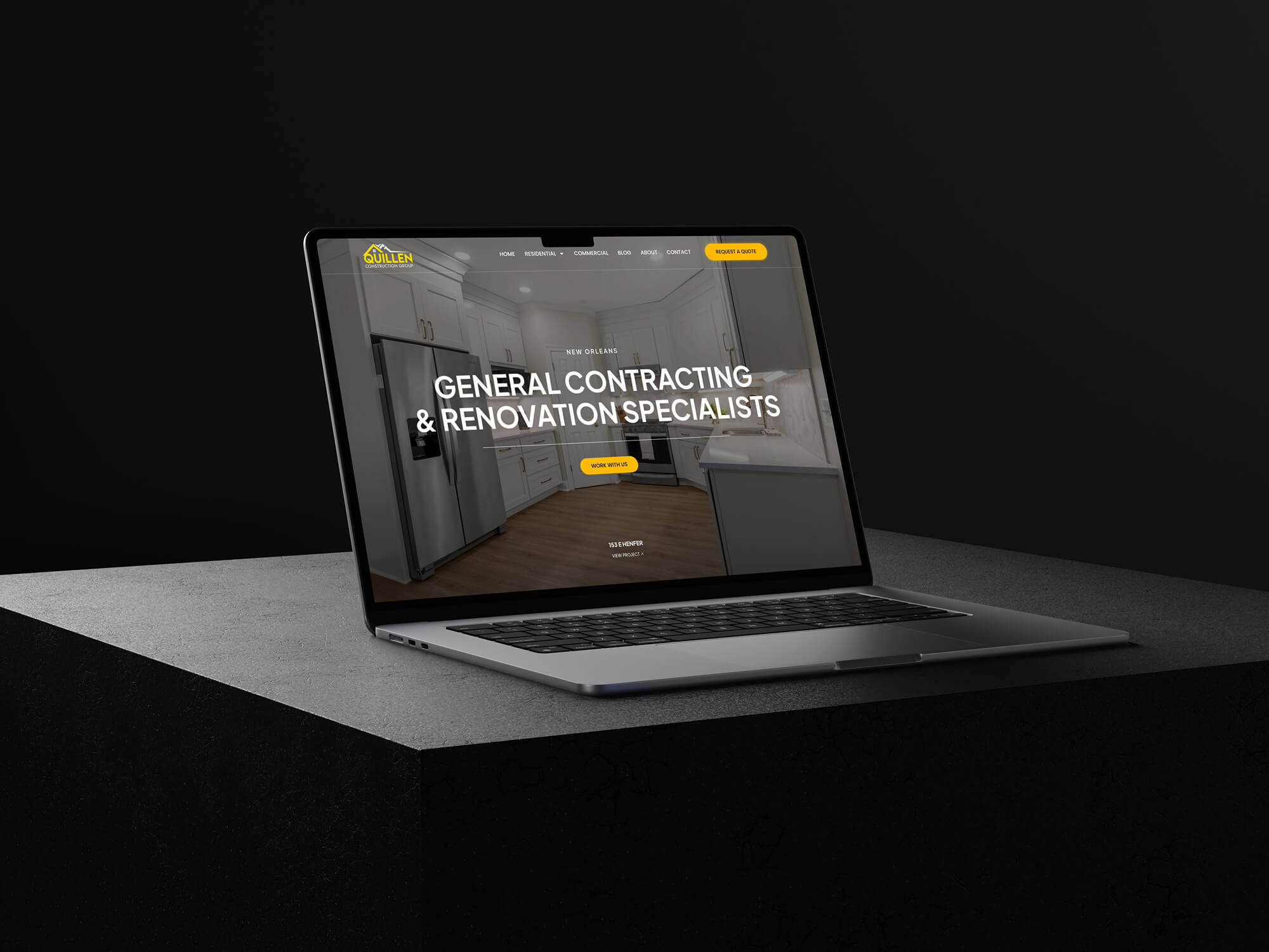 A laptop on a black surface displays a web design Midland MI site with the text "General Contracting & Renovation Specialists" over a kitchen background, featuring yellow buttons and a dark header.