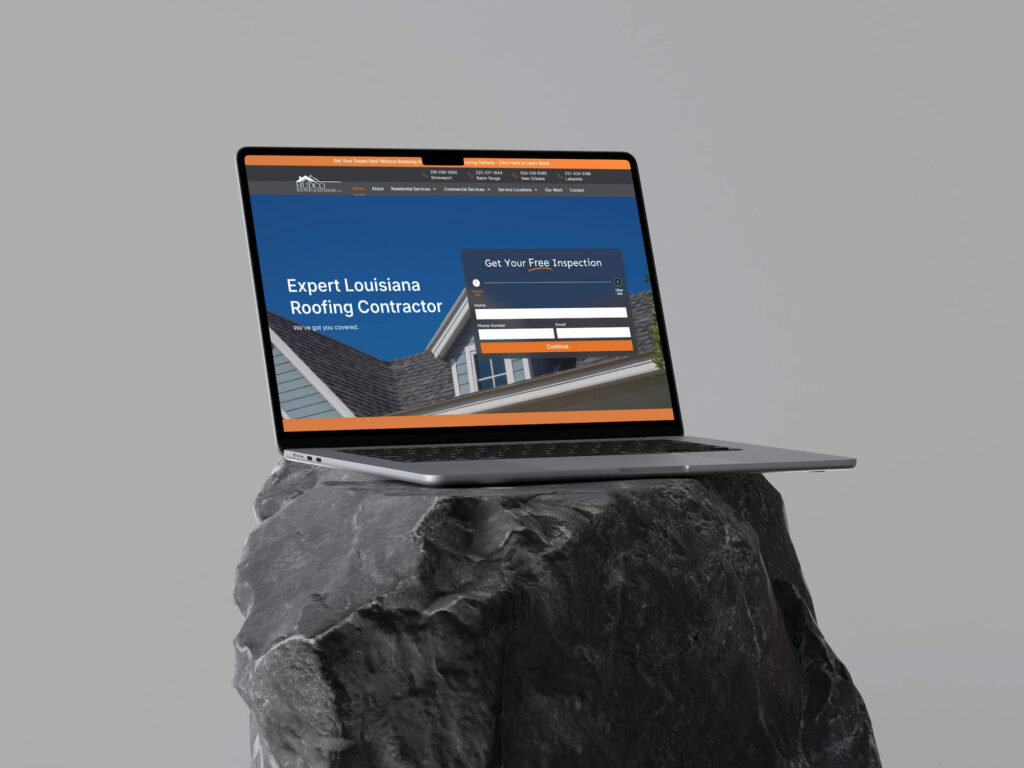 A laptop displaying a roofing contractor website is placed on a dark gray rock against a plain light gray background. The laptop screen shows a contact form and the text “Expert Louisiana Roofing Contractor.”.