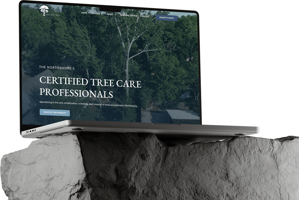 A laptop sits on a rough stone surface, displaying a Website Builds project for "certified tree care professionals" in Dark Mode, with a tree canopy image and navigation menu at the top.