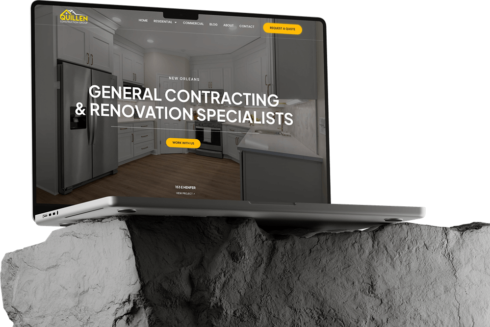 A laptop displaying a website build for general contracting and renovation specialists sits on a rough, gray stone surface. The site features a kitchen background, dark mode design, and a yellow button labeled "Request a Quote.